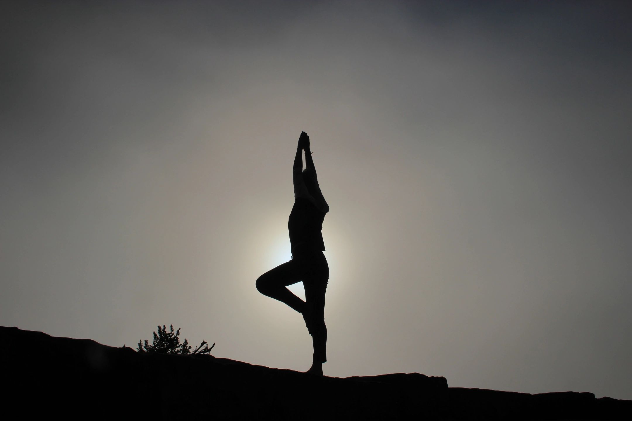 Picture of person doing yoga on a hill